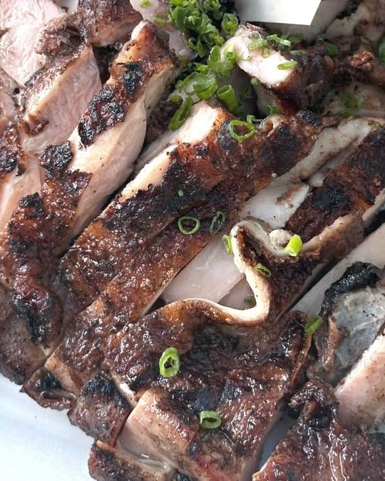 Char grilled chicken thigh at a Shiok BBQ event in Singapore