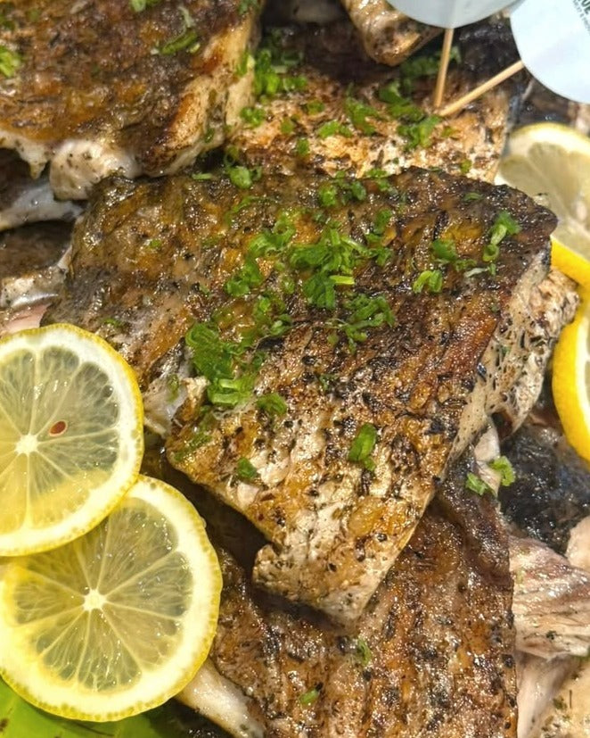Grilled fish portions with lemon at a Shiok BBQ event in Singapore
