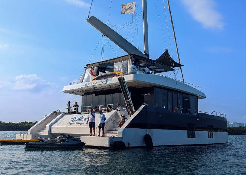 Eagle Wings catamaran from Yacht Maison anchored at sea, for a Shiok BBQ yacht party in Singapore
