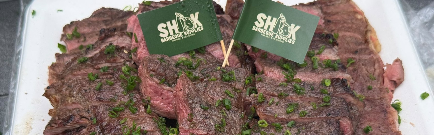 Sliced grilled steak with Shiok BBQ flags