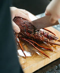 Shiok BBQ Chef handling premium live boston lobster - Premium Barbeque Wholesale with Chef Service Singapore