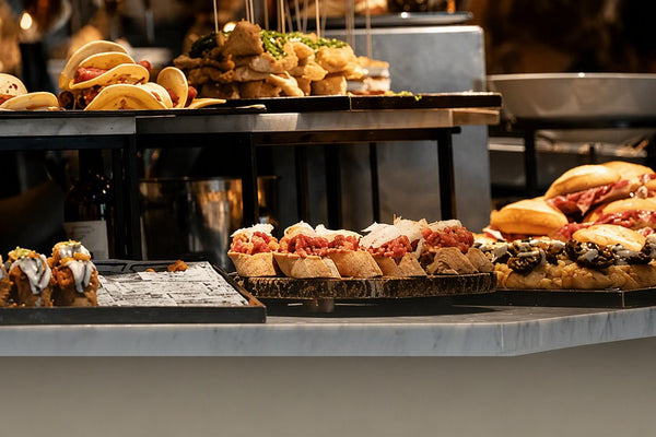 Sliders, mini burgers and finger food laid out on a kids catering buffet counter by Shiok BBQ Singapore