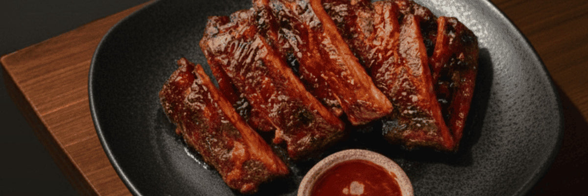 Sliced barbecued lamb ribs with dipping sauce from Shiok BBQ in Singapore