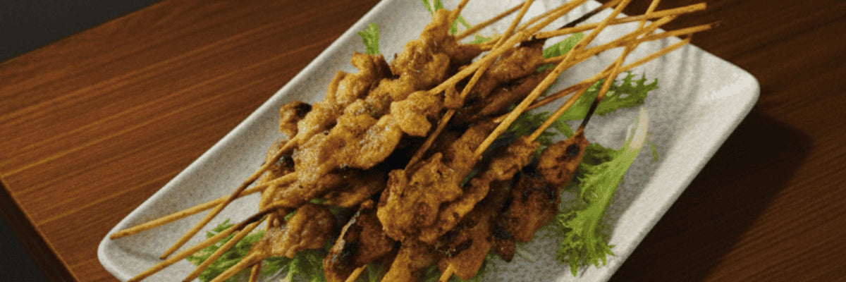 Grilled satay skewers on a serving plate from Shiok BBQ in Singapore