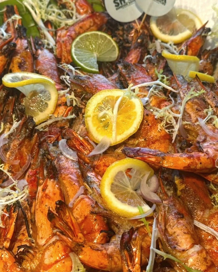 Whole grilled tiger prawns on a banana leaf, Shiok BBQ Singapore