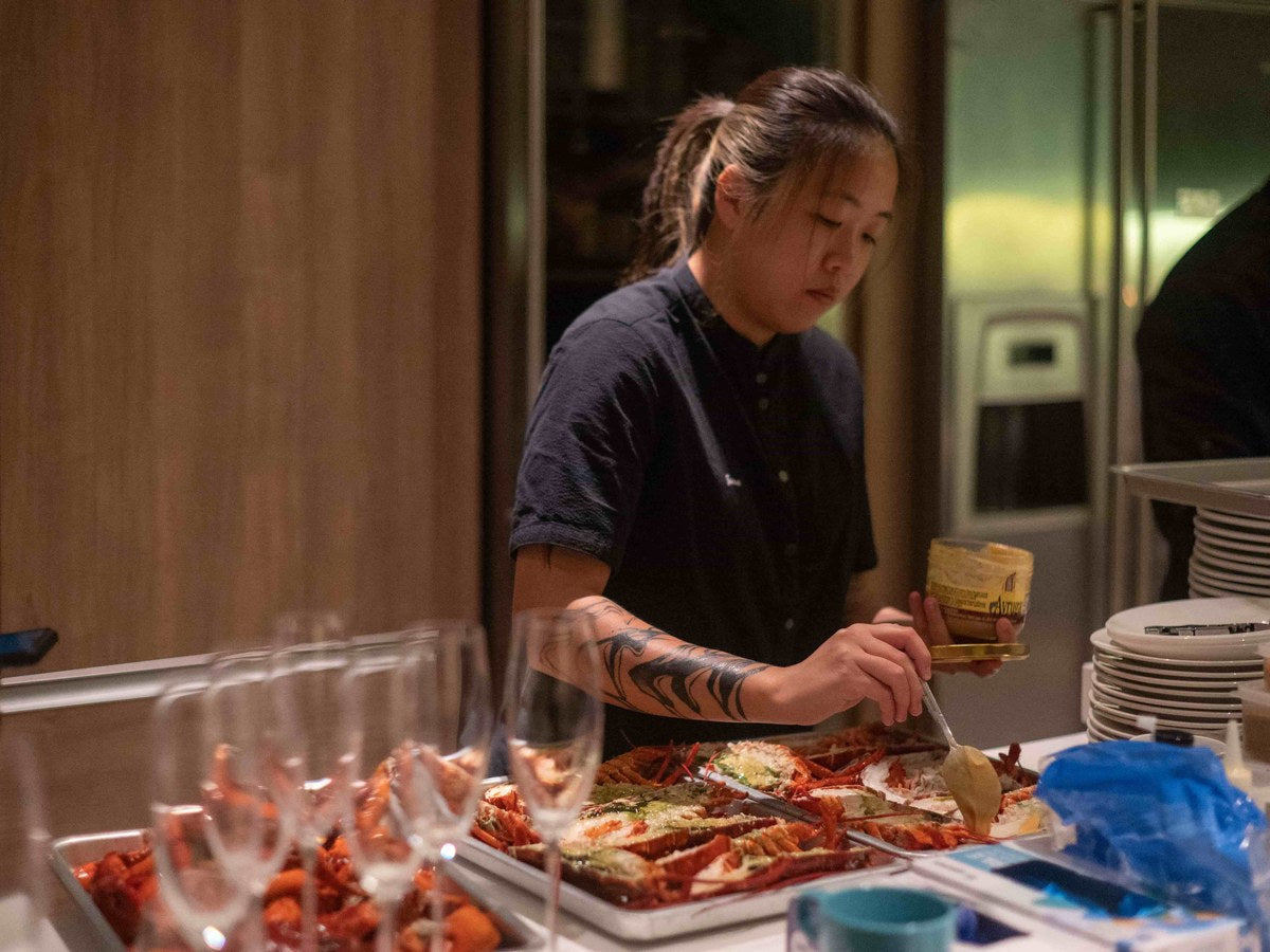 Shiok BBQ chef preparing marinated seafood in the kitchen, Singapore