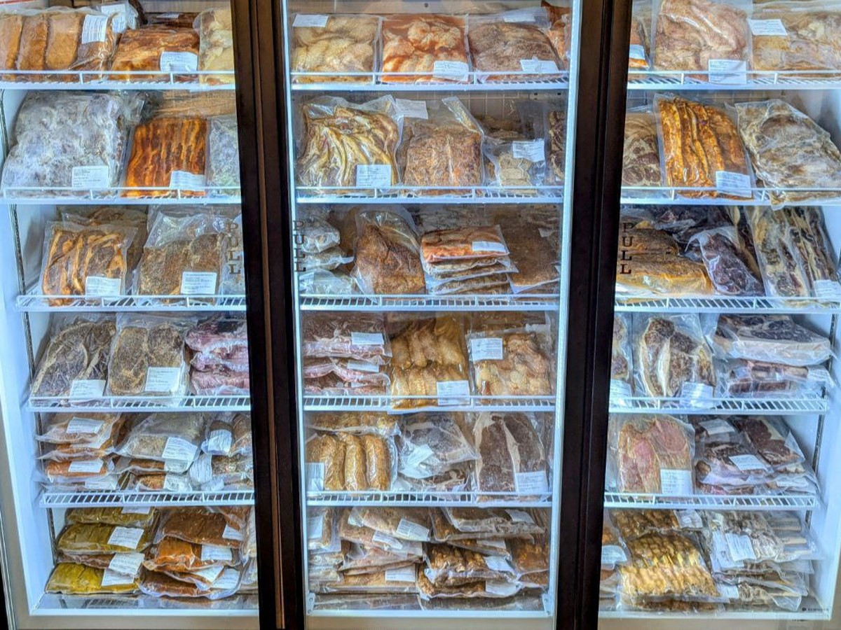 Chillers of marinated meat and seafood at the Shiok BBQ shop on Owen Road, Singapore