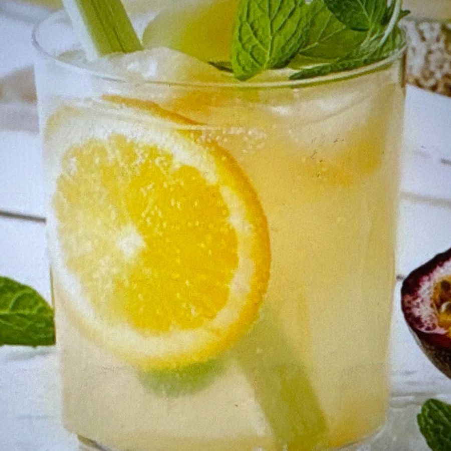Iced tropical mocktail with lemon and mint at a Shiok BBQ event in Singapore